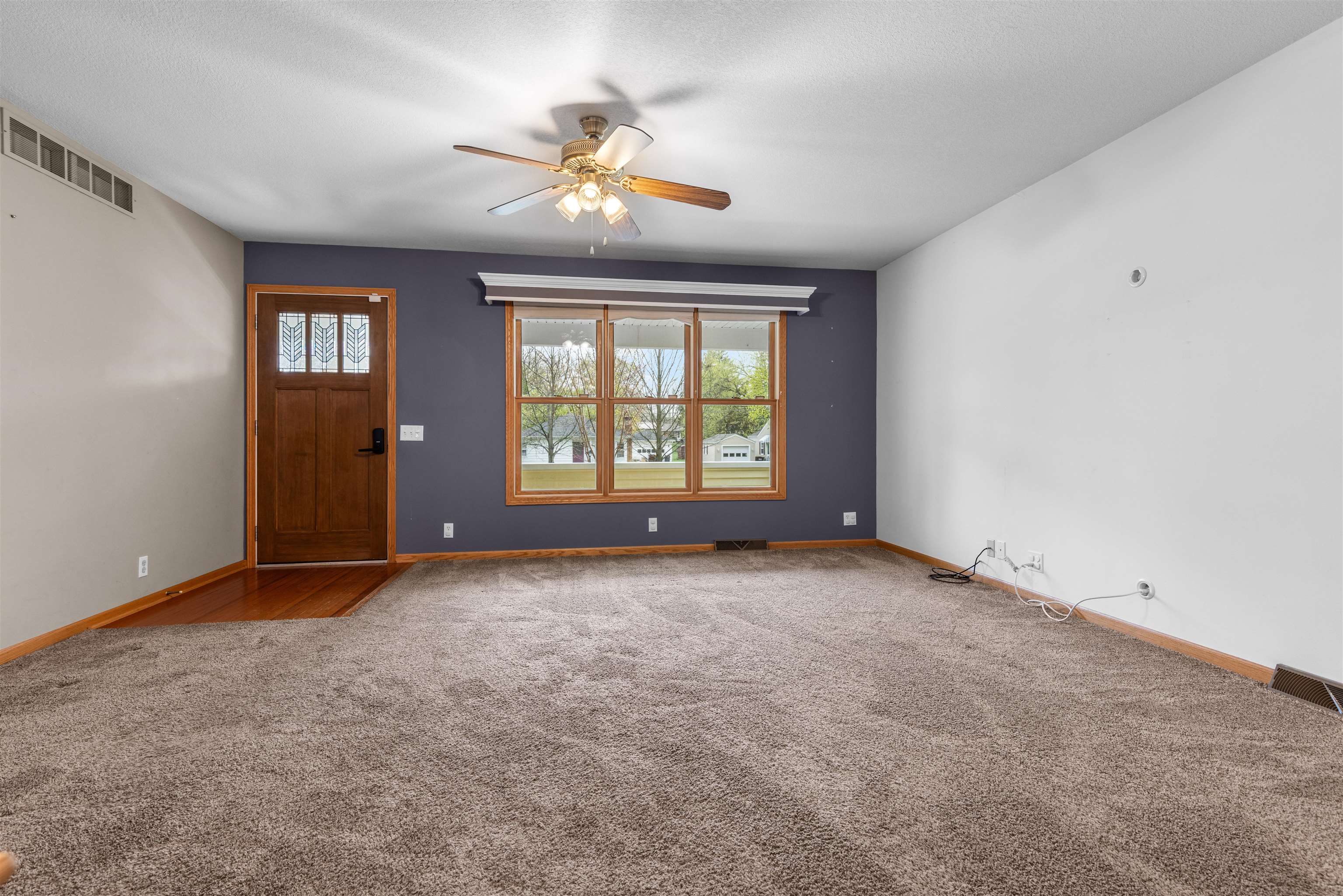 607 South 6th Street Oregon, IL 61061 - Photo 3 of 23 an empty room with windows and chandelier fan