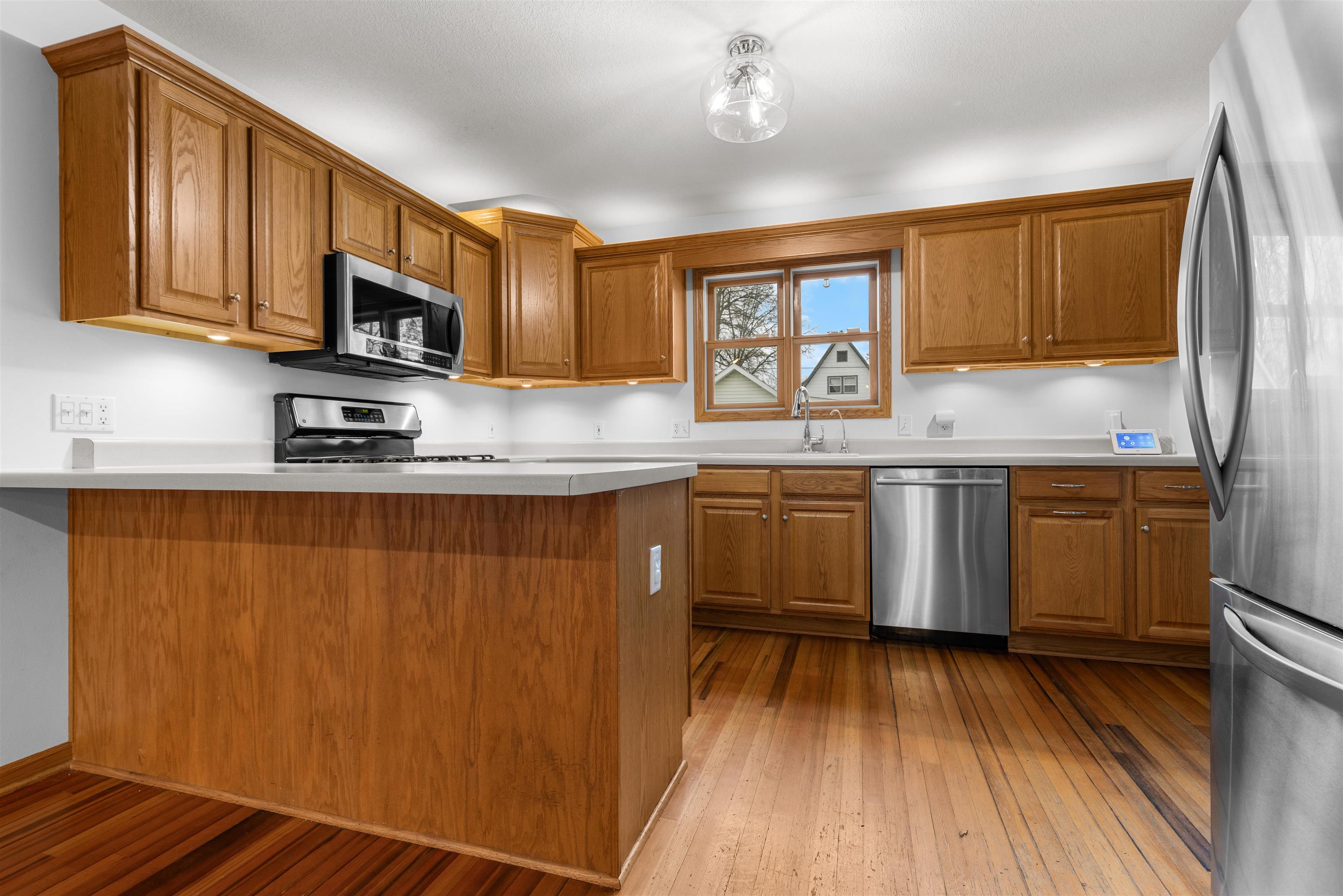 607 South 6th Street Oregon, IL 61061 - Photo 6 of 23 a kitchen with stainless steel appliances granite countertop a sink a stove cabinets and wooden floor