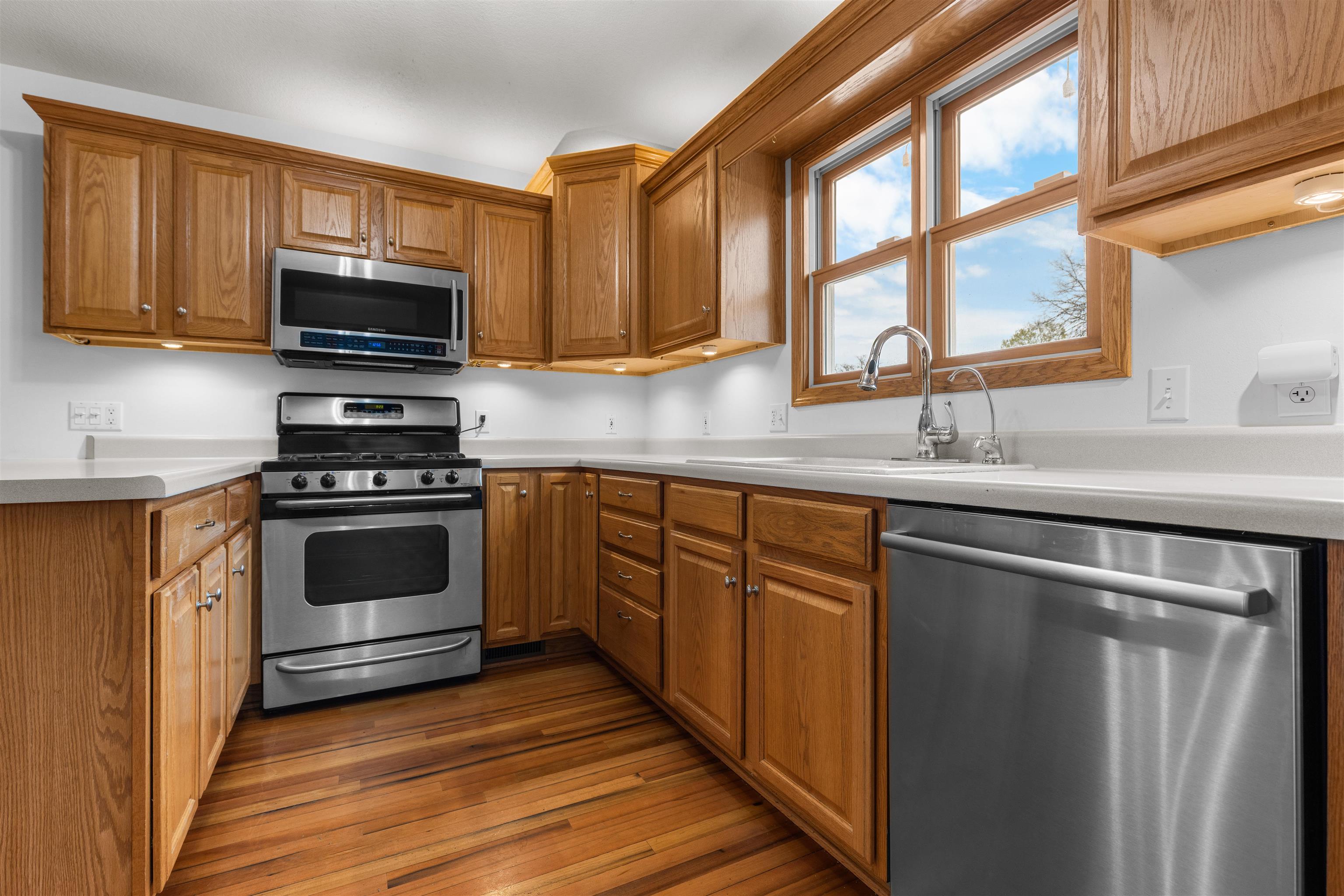 607 South 6th Street Oregon, IL 61061 - Photo 7 of 23 a kitchen with stainless steel appliances a stove sink and microwave