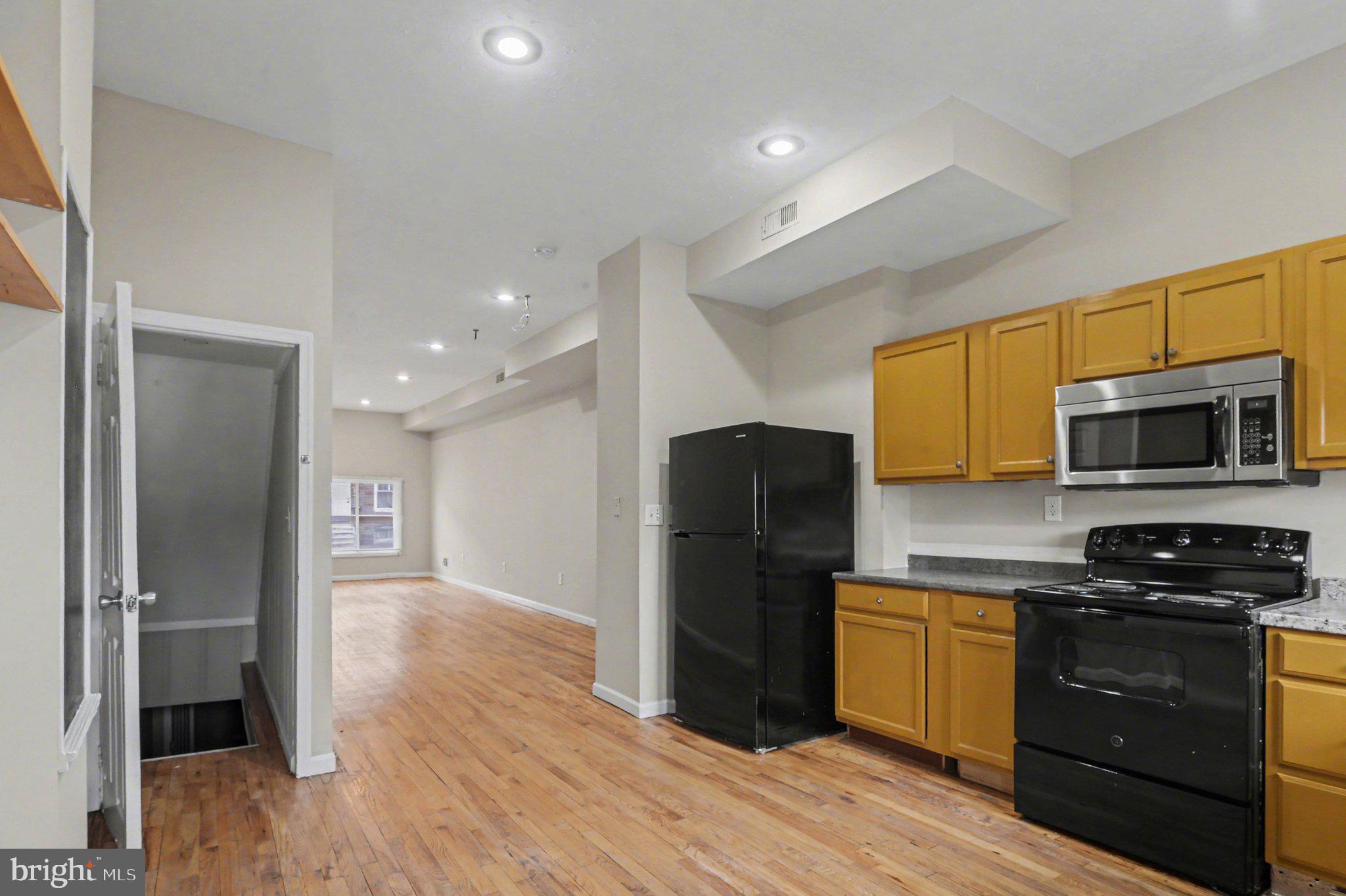3418 East Baltimore Street Baltimore, MD 21224 - Photo 13 of 40 a kitchen with a refrigerator a stove top oven a sink and dishwasher