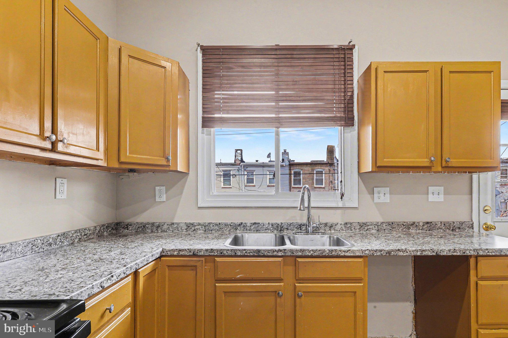 3418 East Baltimore Street Baltimore, MD 21224 - Photo 15 of 40 a kitchen with stainless steel appliances granite countertop a sink and cabinets