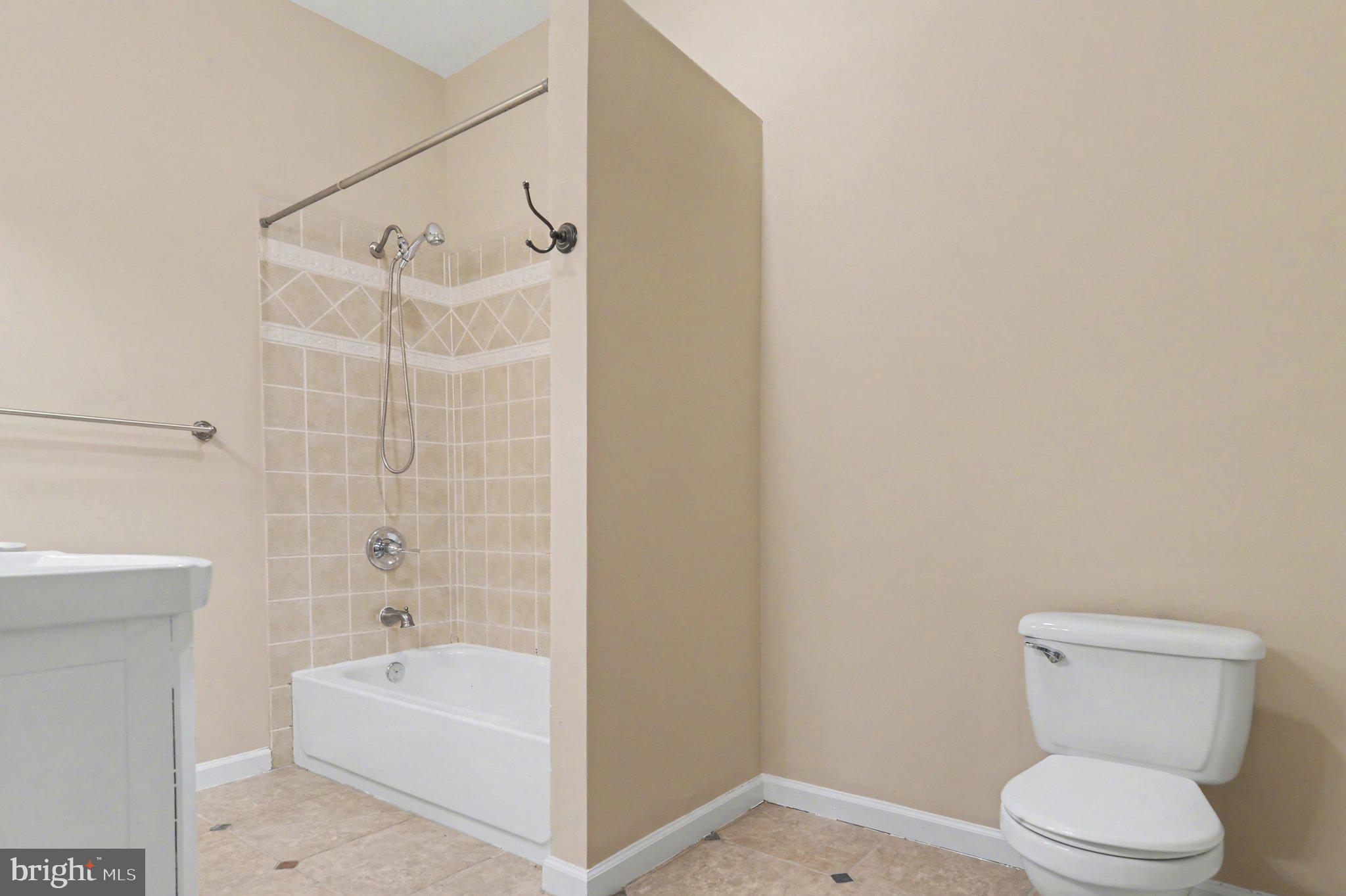 3418 East Baltimore Street Baltimore, MD 21224 - Photo 20 of 40 a white toilet sitting next to a bath tub