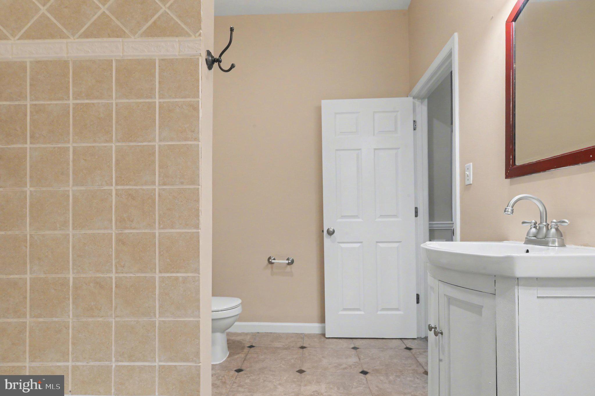 3418 East Baltimore Street Baltimore, MD 21224 - Photo 22 of 40 a bathroom with a sink toilet and shower