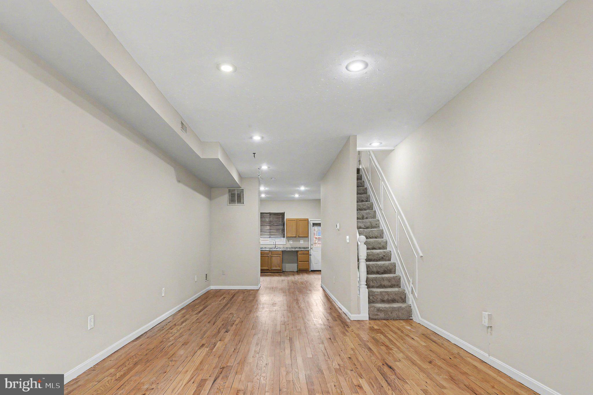3418 East Baltimore Street Baltimore, MD 21224 - Photo 5 of 40 a view of hallway with stairs and wooden floor
