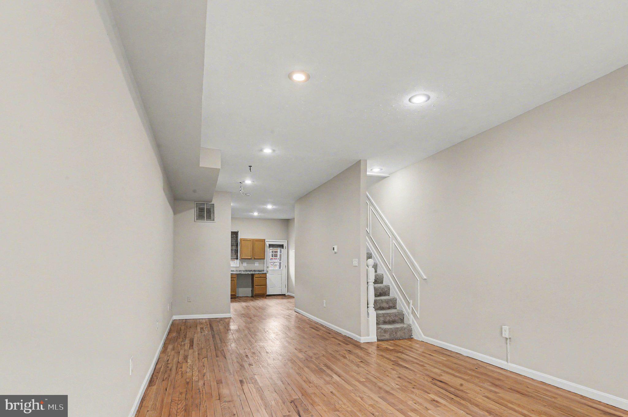 3418 East Baltimore Street Baltimore, MD 21224 - Photo 6 of 40 a view of a hallway with wooden floor and staircase