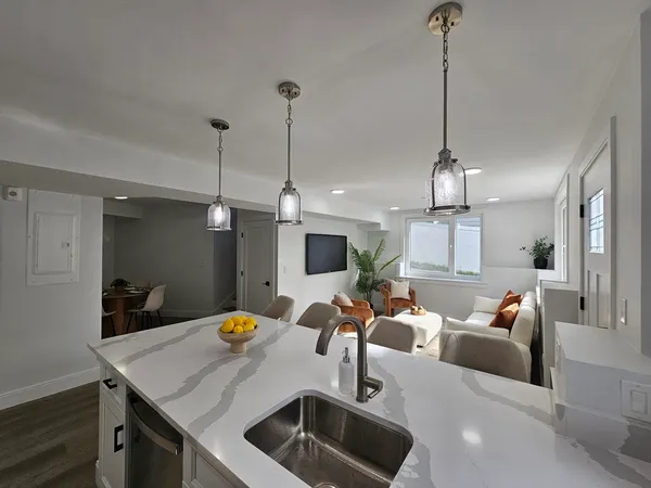 a view of a room with furniture and chandelier