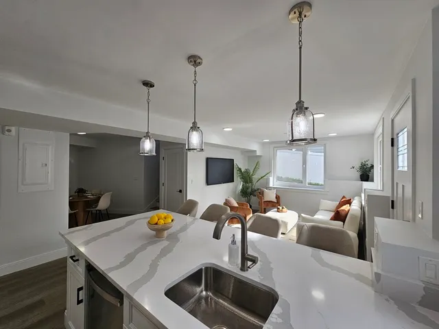 a view of a room with furniture and chandelier