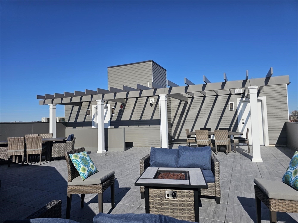 64 Alpine Street, Unit 104 Boston, MA 02119 - Photo 11 of 15 a view of entryway livingroom and hall with wooden floor