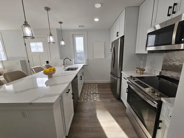a kitchen with a sink stove and refrigerator