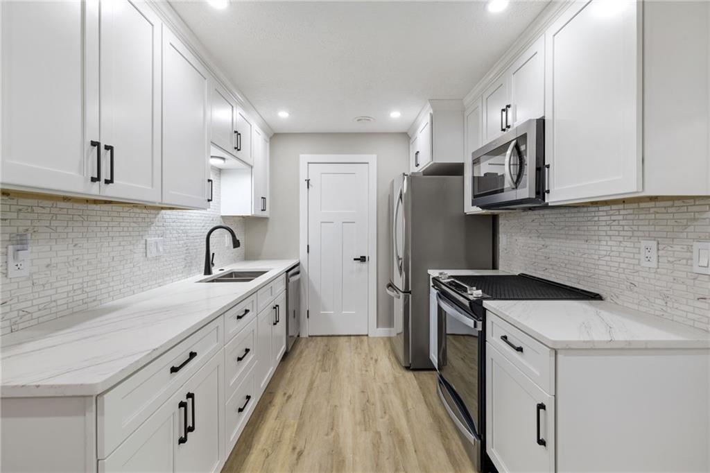 300 Gilkeson Road, Unit 10B Pittsburgh, PA 15228 - Photo 15 of 31 a kitchen with stainless steel appliances granite countertop a sink stove refrigerator and cabinets