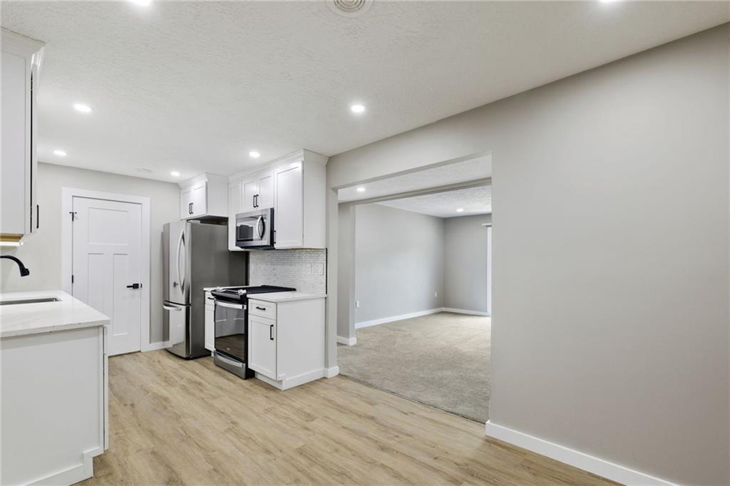 300 Gilkeson Road, Unit 10B Pittsburgh, PA 15228 - Photo 16 of 31 a kitchen with stainless steel appliances a refrigerator and a stove top oven
