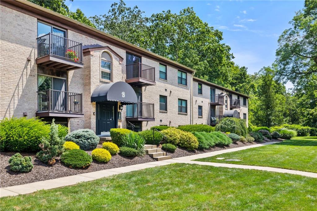300 Gilkeson Road, Unit 10B Pittsburgh, PA 15228 - Photo 2 of 31 a front view of a house with a garden and plants