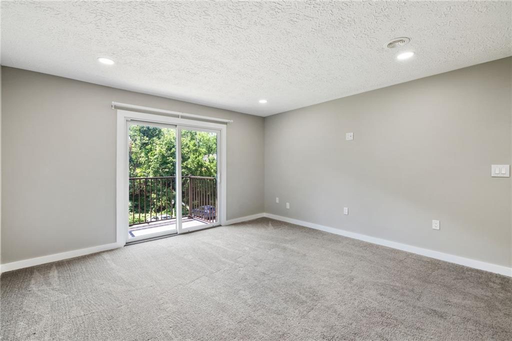 300 Gilkeson Road, Unit 10B Pittsburgh, PA 15228 - Photo 9 of 31 a view of an empty room with wooden floor and a window