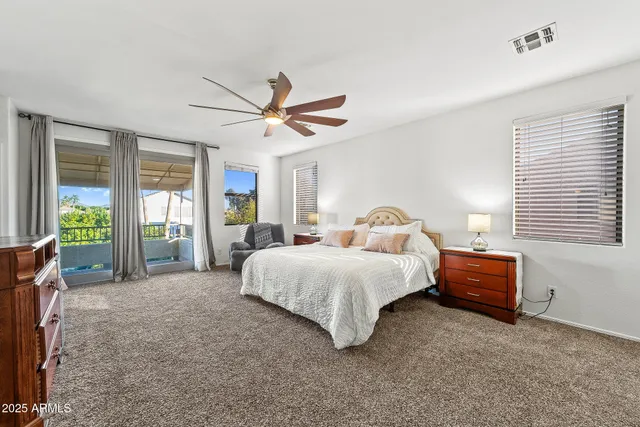 a spacious bedroom with a bed and a large window