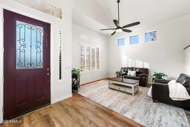 a living room with furniture and wooden floor