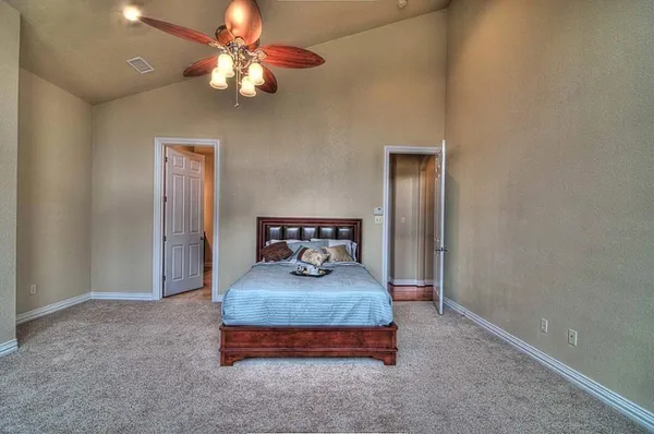 a bedroom with bed and a chandelier