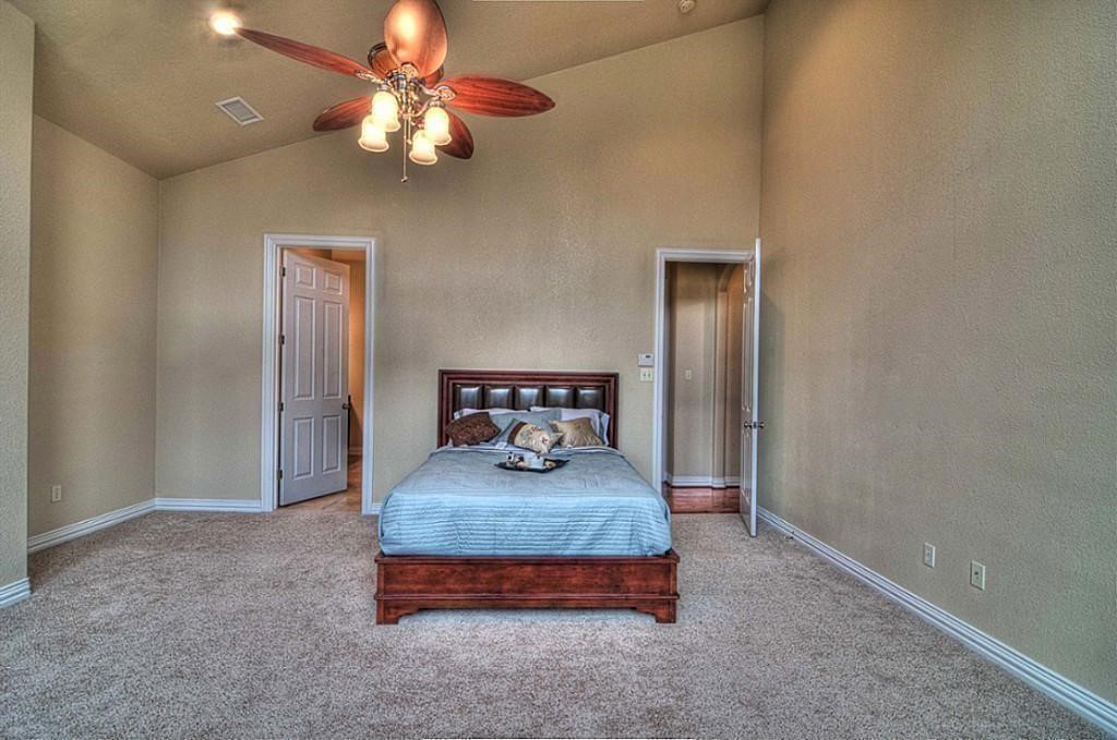 3505 Jackson Street Houston, TX 77004 - Photo 19 of 32 a bedroom with bed and a chandelier