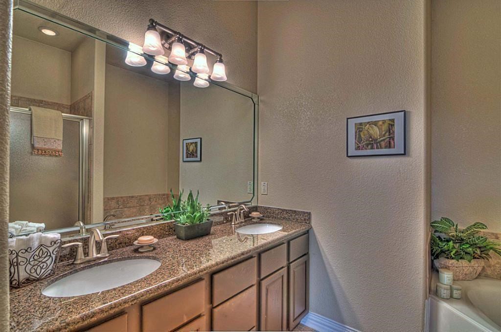 3505 Jackson Street Houston, TX 77004 - Photo 20 of 32 a bathroom with a granite countertop sink a large mirror and a shower