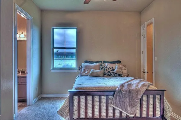 a bed sitting in a bedroom next to a window