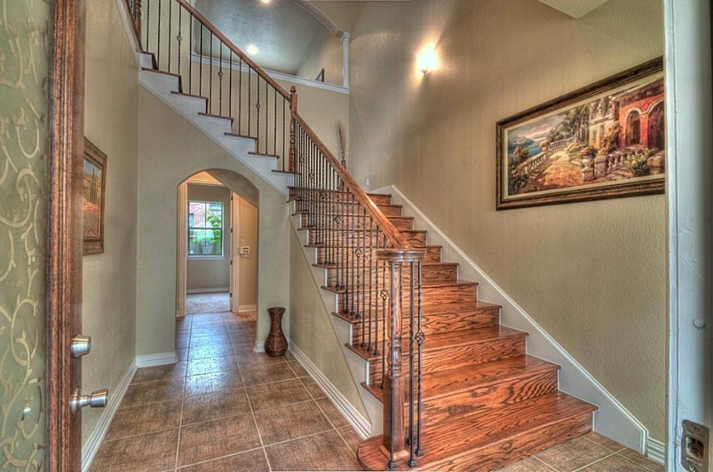 3505 Jackson Street Houston, TX 77004 - Photo 4 of 32 a view of staircase with lots of frames on wall and wooden floor