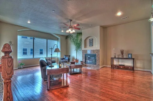 a living room with fireplace furniture and a wooden floor