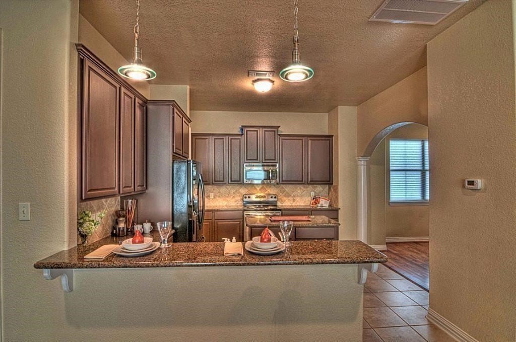 3505 Jackson Street Houston, TX 77004 - Photo 9 of 32 a kitchen with kitchen island granite countertop a sink and cabinets