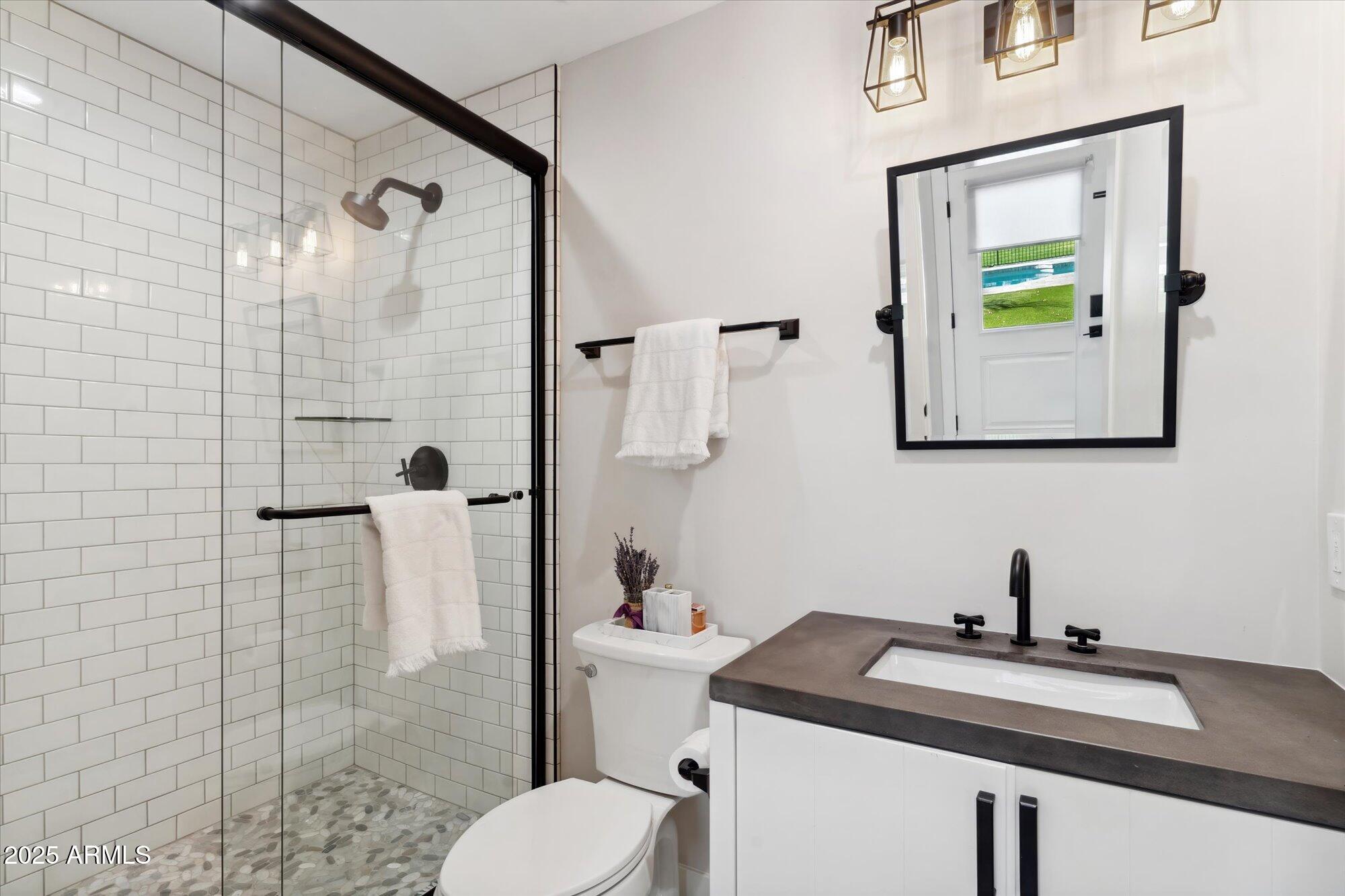 620 West McLellan Boulevard Phoenix, AZ 85013 - Photo 16 of 26 a bathroom with a sink toilet and shower
