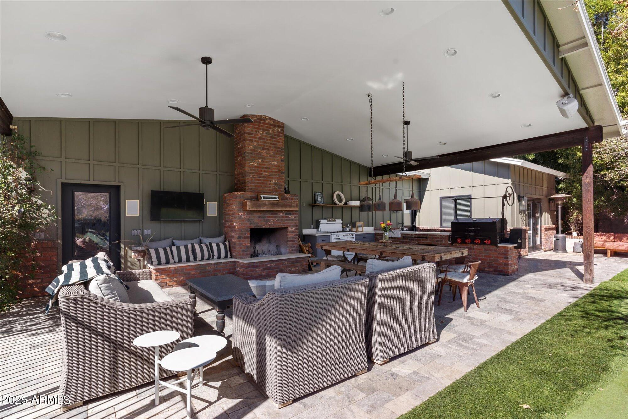 620 West McLellan Boulevard Phoenix, AZ 85013 - Photo 19 of 26 a living room with furniture a fireplace and a flat screen tv