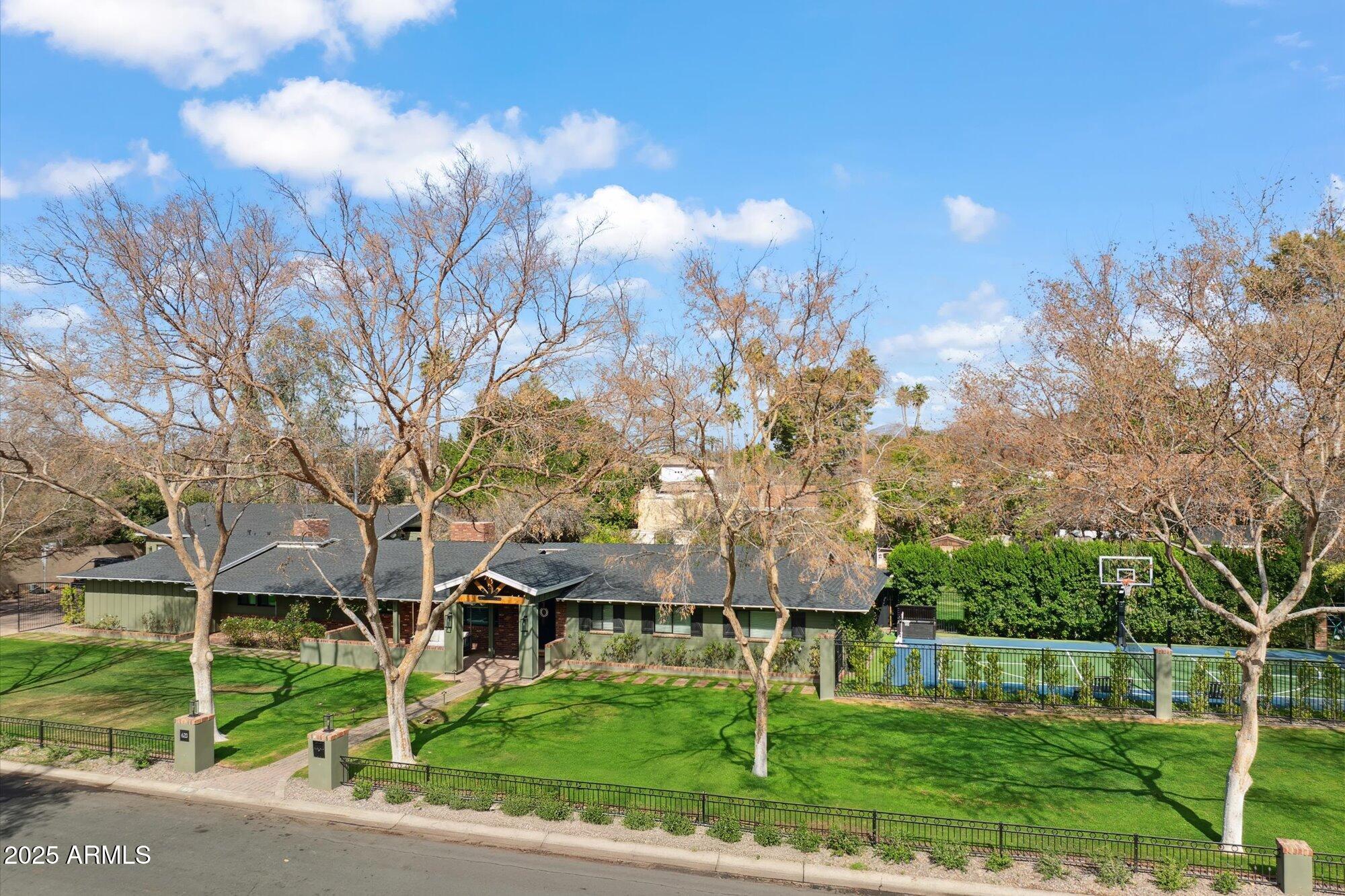 620 West McLellan Boulevard Phoenix, AZ 85013 - Photo 2 of 26 a front view of a house with a yard and trees