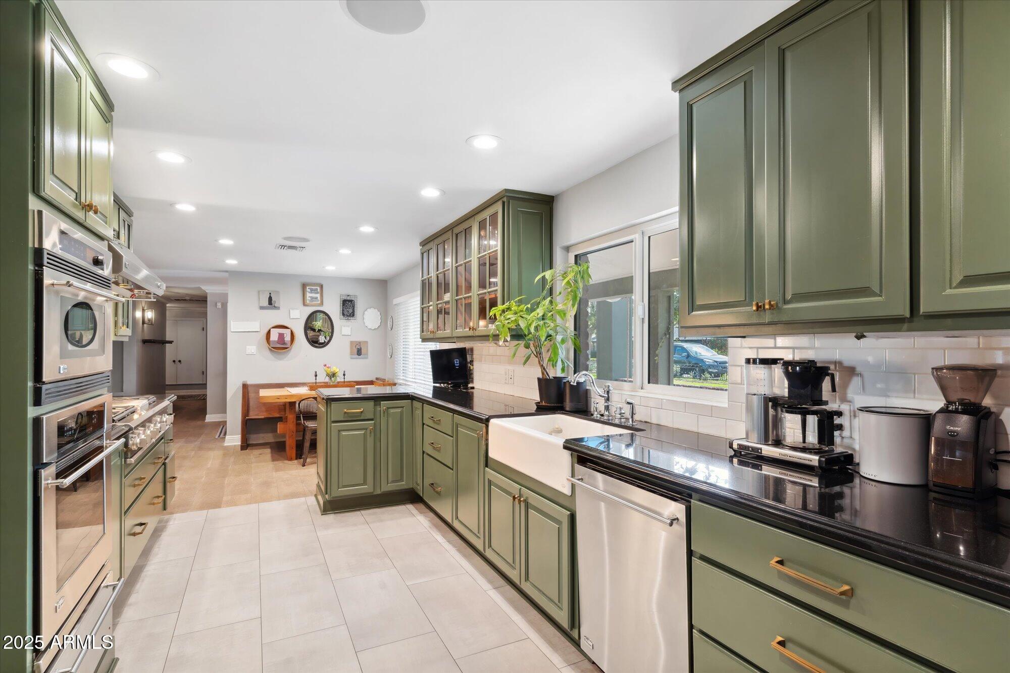 620 West McLellan Boulevard Phoenix, AZ 85013 - Photo 24 of 26 a kitchen with stainless steel appliances granite countertop a sink and cabinets