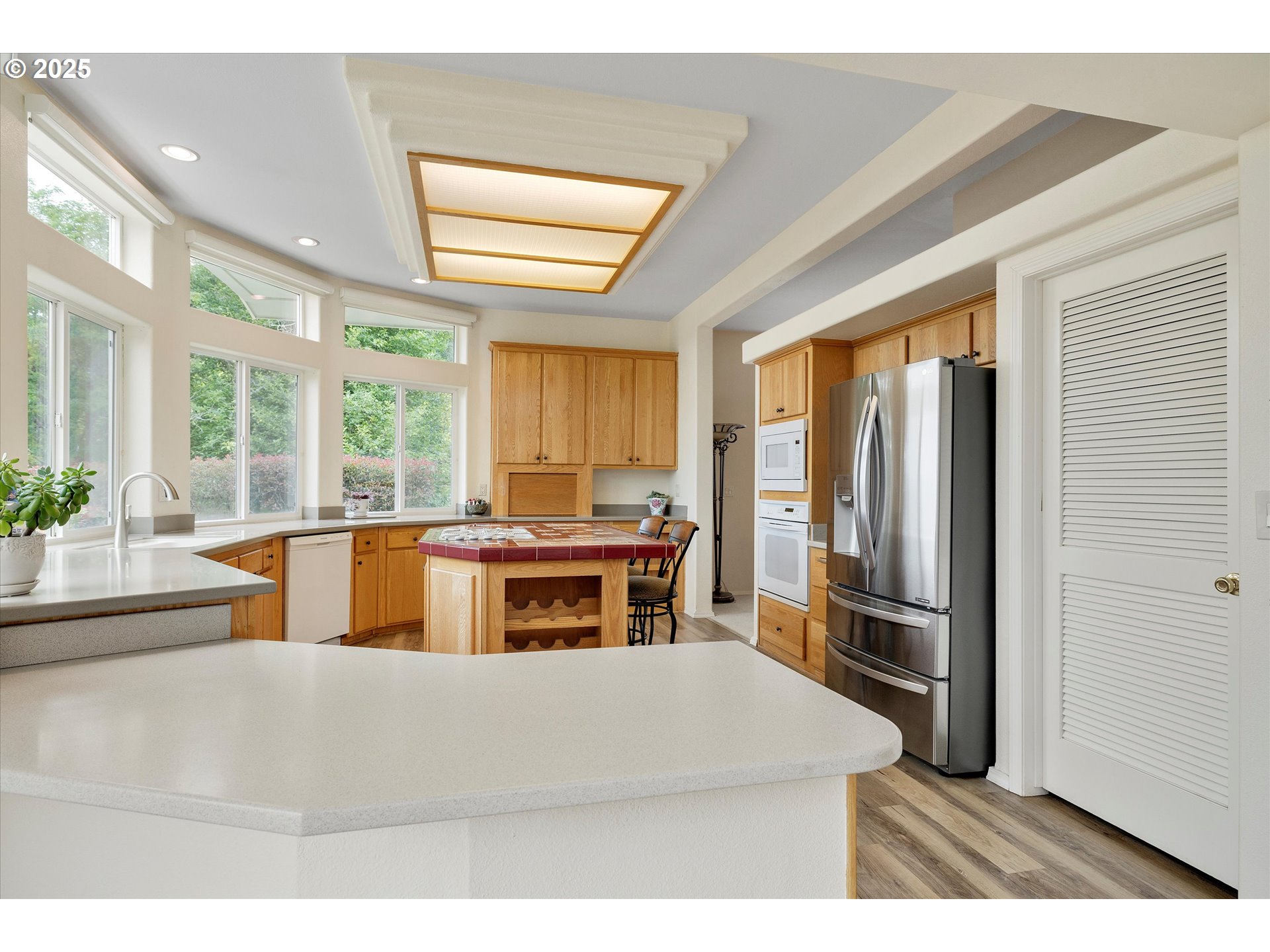 7340-7350 Smith Road Monmouth, OR 97361 - Photo 18 of 40 a kitchen with stainless steel appliances kitchen island granite countertop a refrigerator and a sink