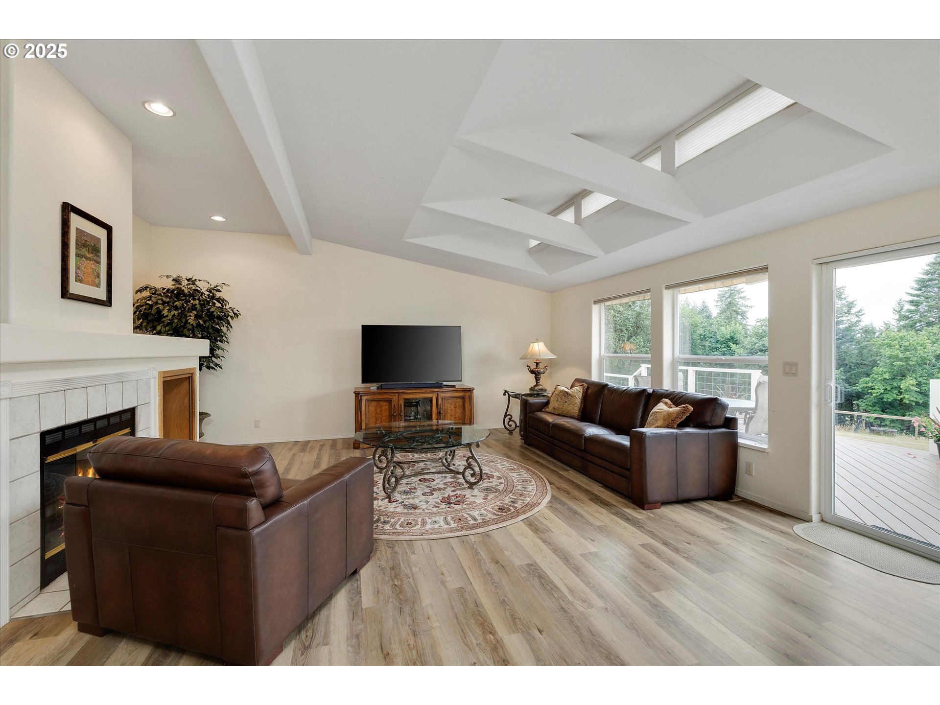 7340-7350 Smith Road Monmouth, OR 97361 - Photo 19 of 40 a living room with furniture a flat screen tv and a fireplace