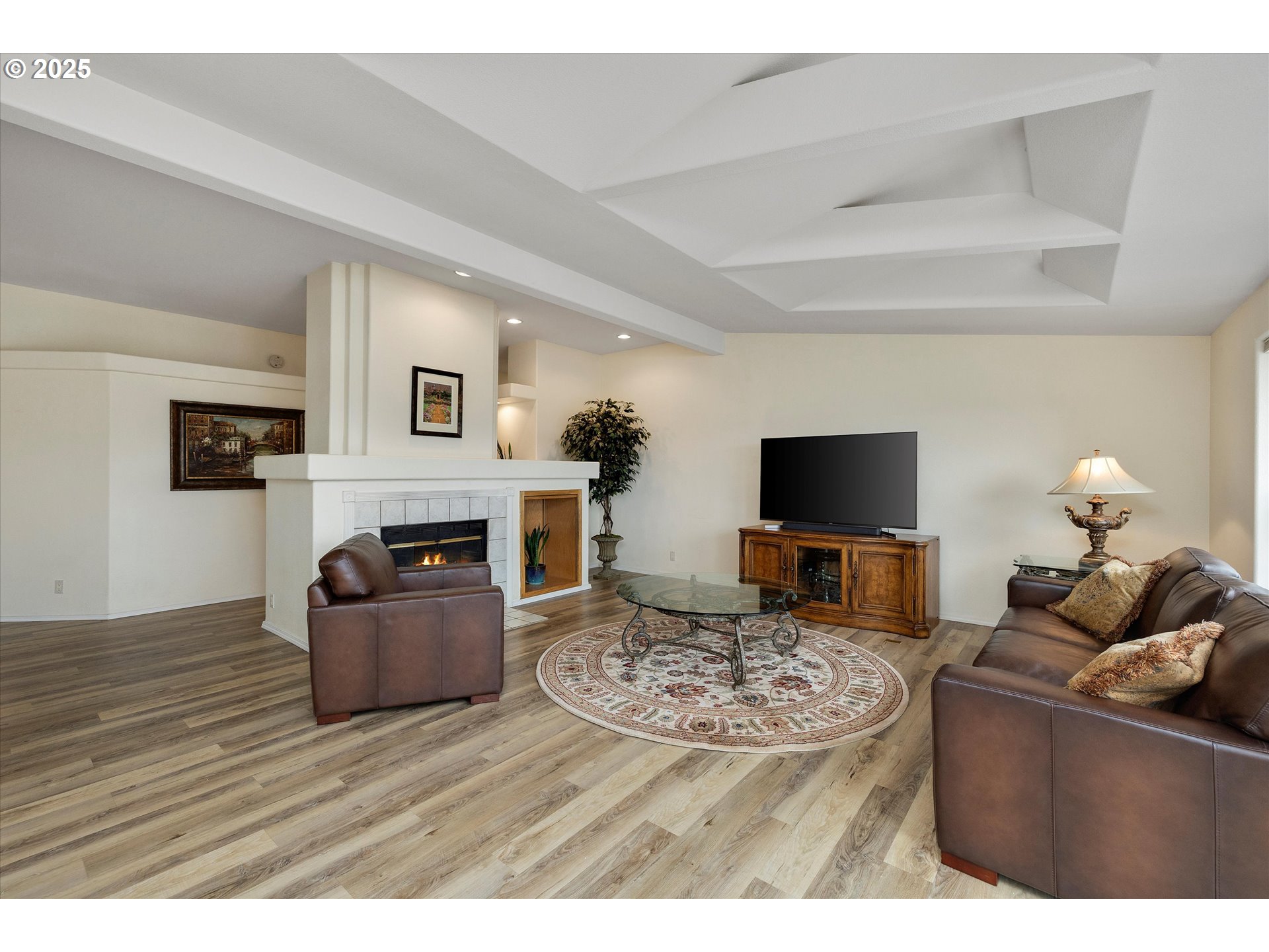 7340-7350 Smith Road Monmouth, OR 97361 - Photo 20 of 40 a living room with furniture a flat screen tv and a fireplace
