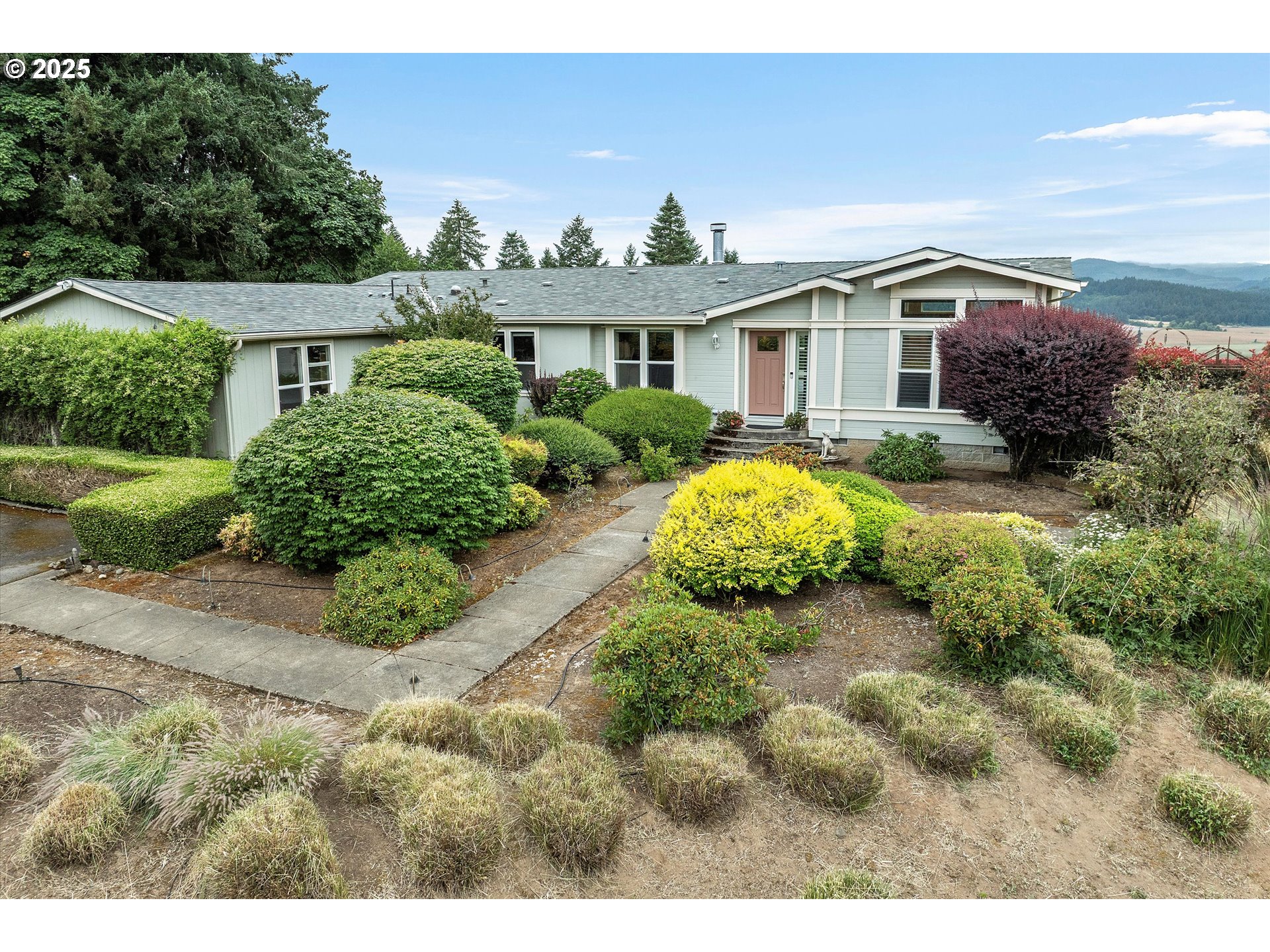 7340-7350 Smith Road Monmouth, OR 97361 - Photo 3 of 40 a view of a house with a yard and potted plants