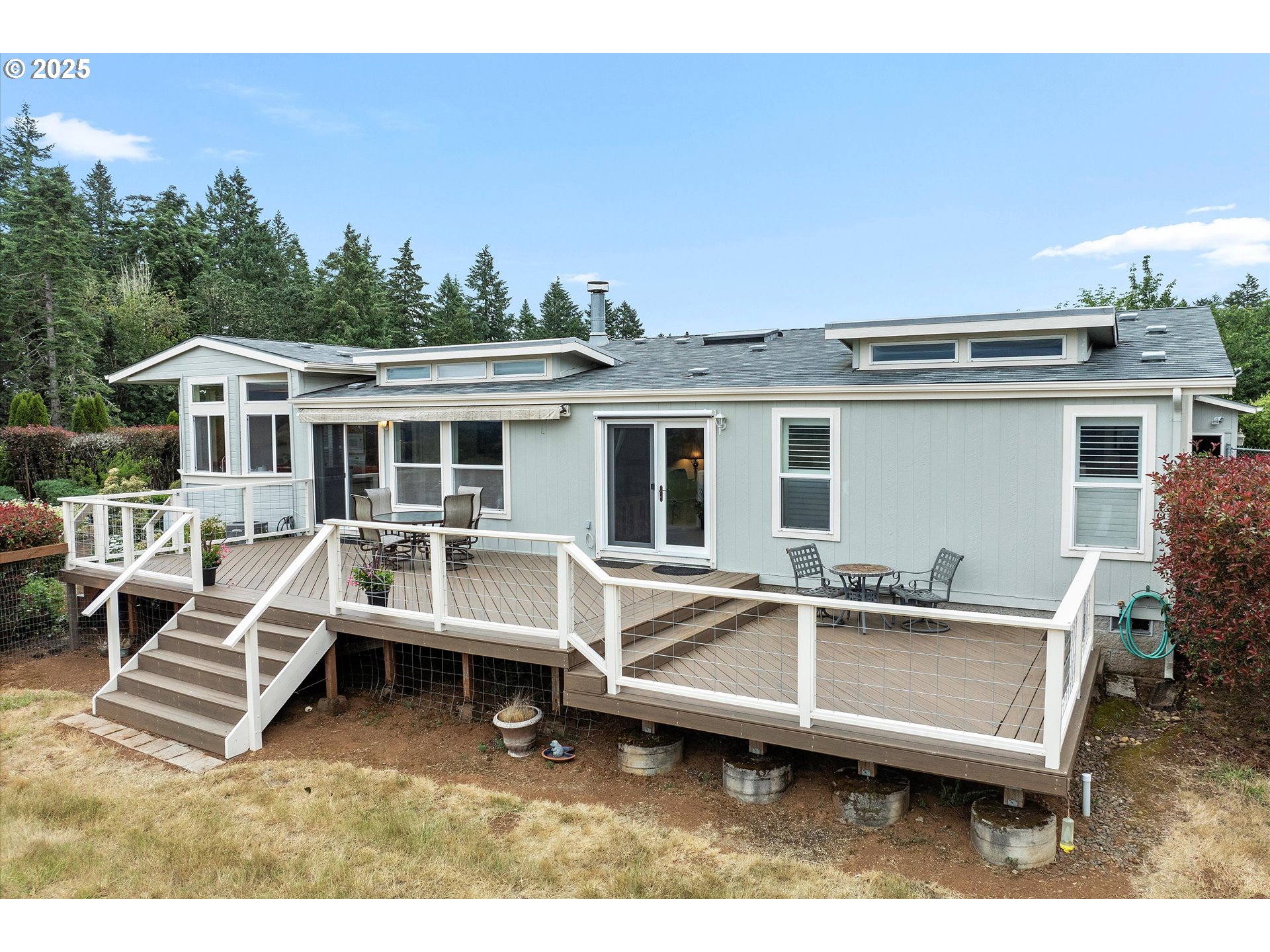 7340-7350 Smith Road Monmouth, OR 97361 - Photo 5 of 40 a view of a house with pool chairs and wooden fence