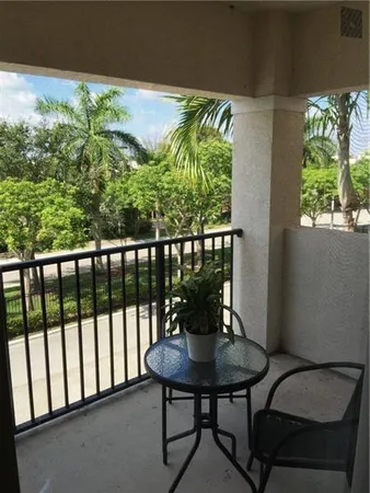 a view of a balcony with chairs