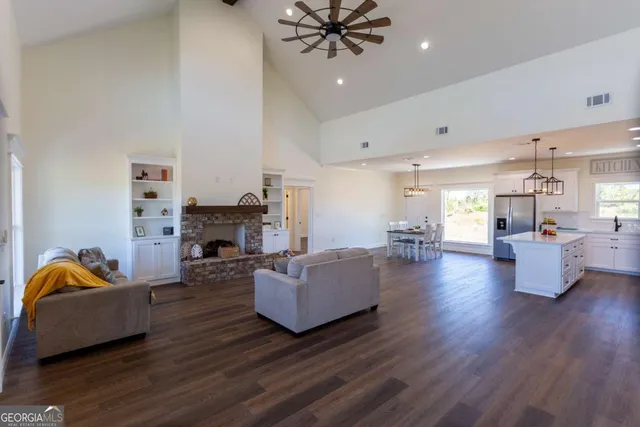 a living room with furniture fireplace and chandelier