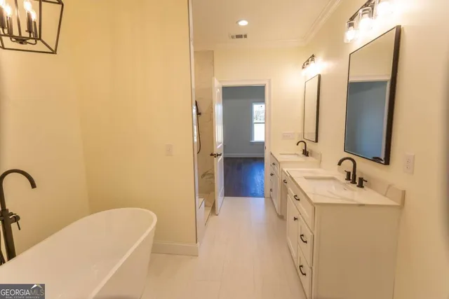 a view of a hallway with wooden floor and entryway