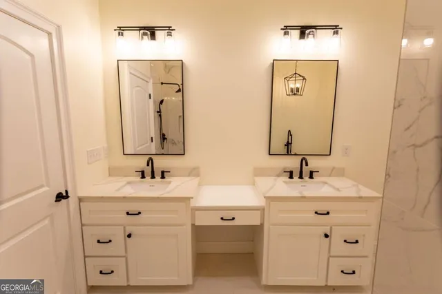 a view of an empty room with wooden floor and a ceiling fan
