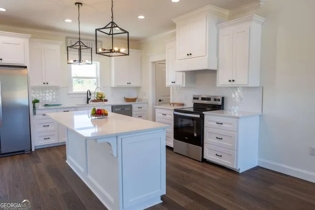 a dining room with wooden floor a chandelier a wooden table and chairs