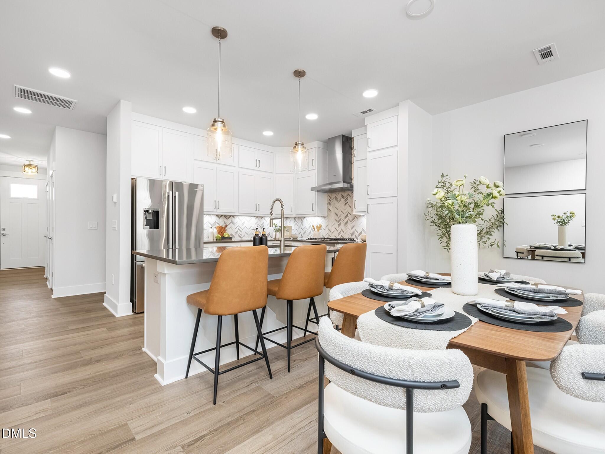 620 Cable Court Apex, NC 27523 - Photo 1 of 10 a kitchen with a table and chairs in it