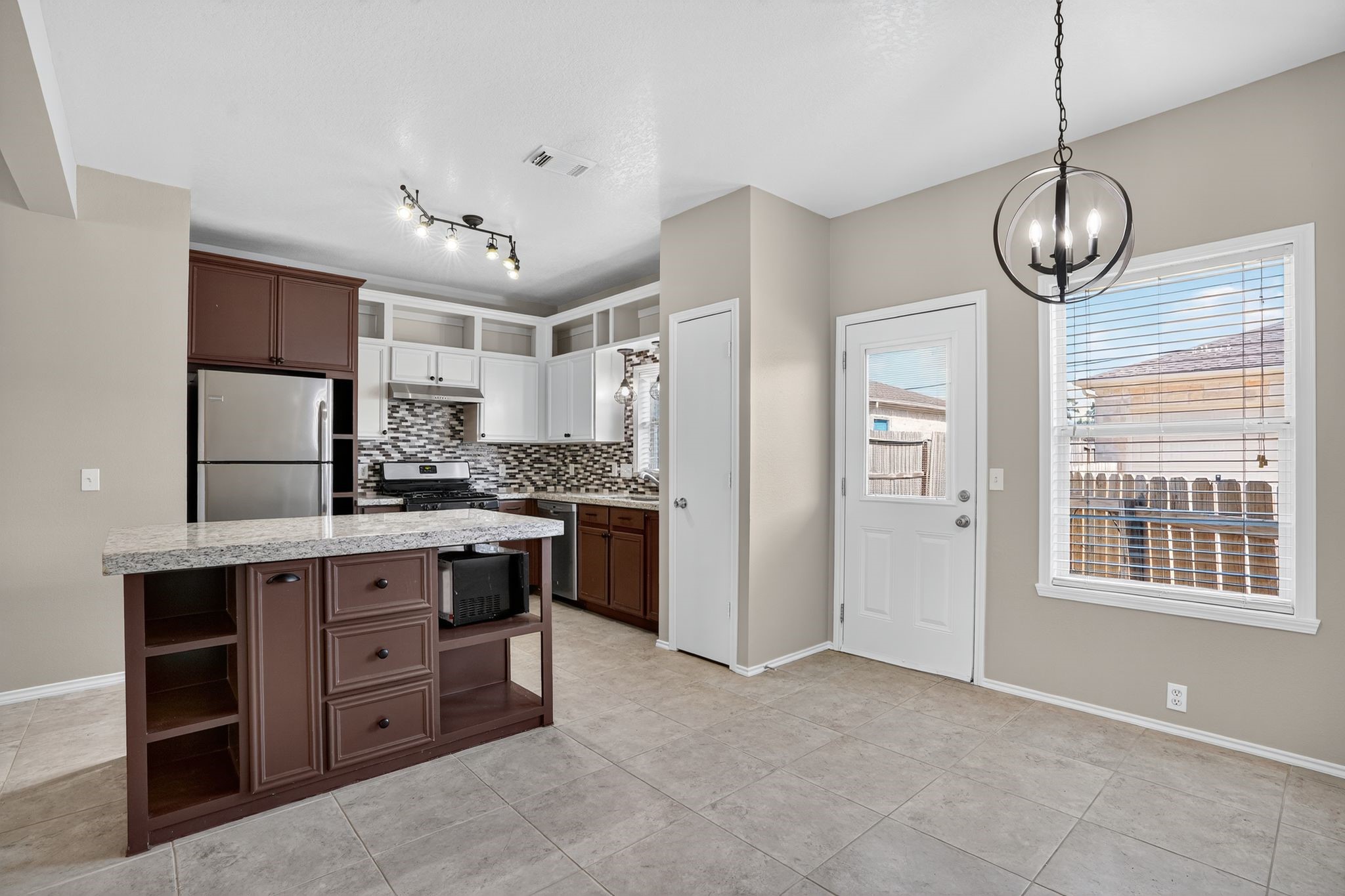 2814 Legends Crest Drive Spring, TX 77386 - Photo 9 of 34 a kitchen with a refrigerator and chandelier