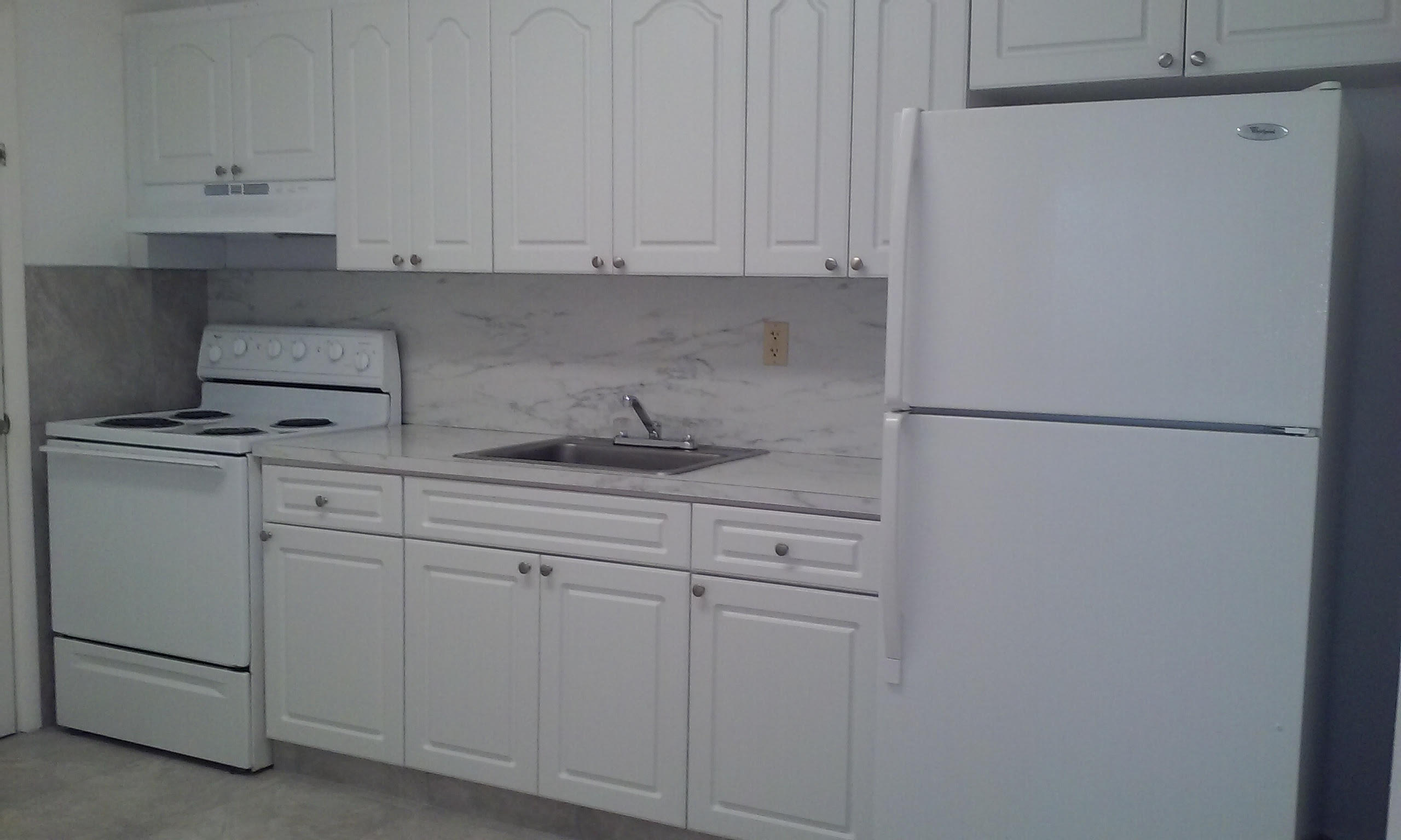 715 West 29th Street Hialeah, FL 33012 - Photo 6 of 6 a kitchen with white cabinets and white appliances