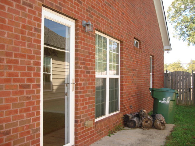 421 Bob White Road Macon, GA 31216 - Photo 19 of 23 a view of a brick house with a chair and a table