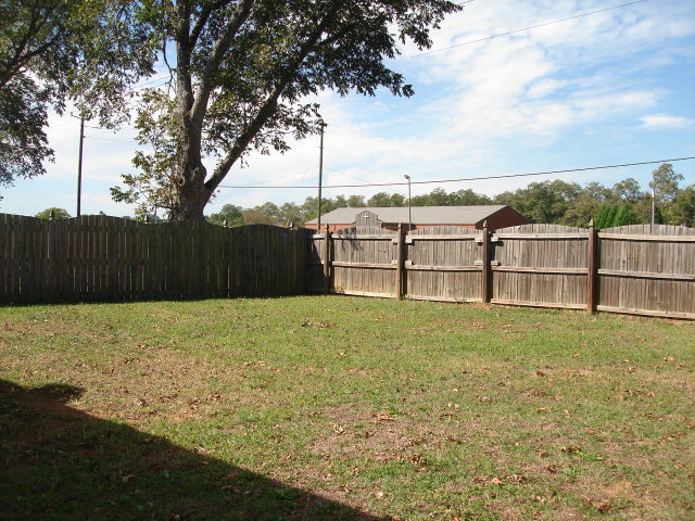 421 Bob White Road Macon, GA 31216 - Photo 20 of 23 a backyard of a house with lots of green space