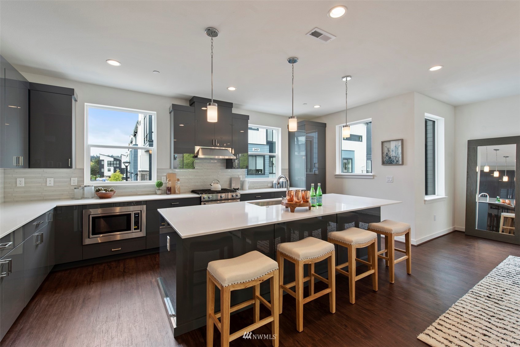 21921 25th Avenue Southeast, Unit A Bothell, WA 98021 - Photo 5 of 25 a large kitchen with a table and chairs