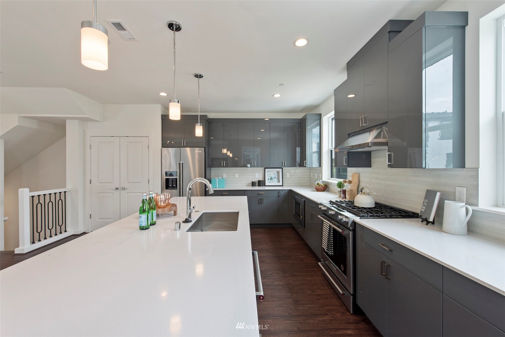 21921 25th Avenue Southeast, Unit A Bothell, WA 98021 - Photo 6 of 25 a large kitchen with stainless steel appliances a large counter top a stove a chimney a sink and a refrigerator