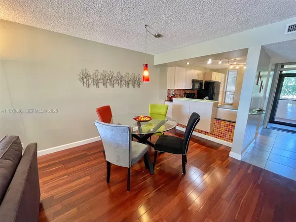 a dining room with furniture and wooden floor