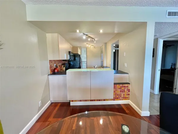 a view of a livingroom with kitchen and furniture