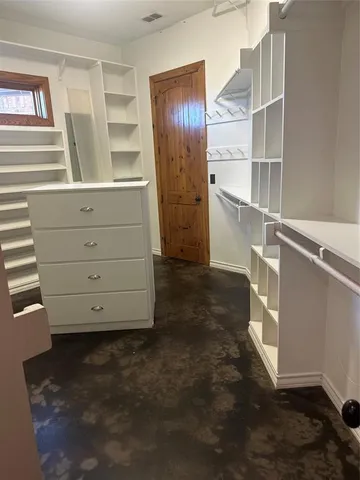 a view of an empty room with cabinet and stairs